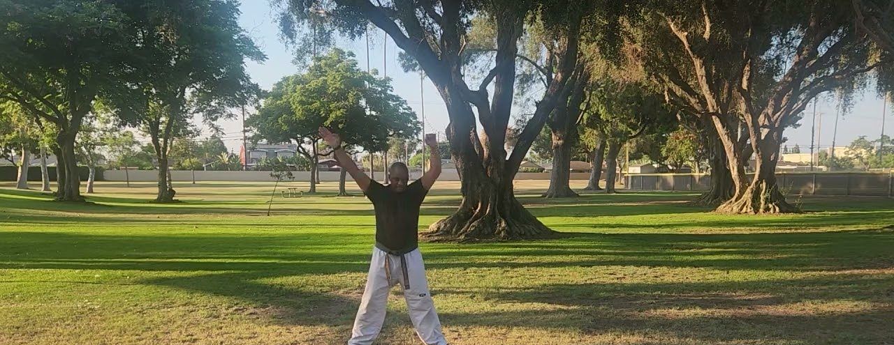 Master William leading a warm-up on the grass at Brookhurst Park
